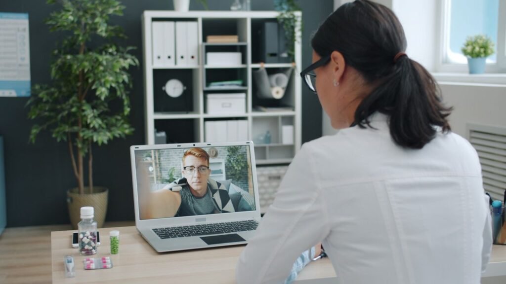 Doctor engaged in a video call with patient, discussing health online.